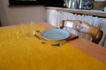 Table setting and arrangement decorated with ceramic plate and stainless steel cutlery