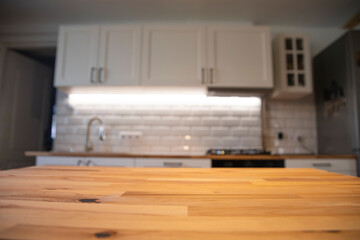 A clean and tidy kitchen with illuminating white walls