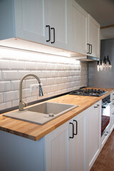 A beautiful kitchen detail with white cabinets