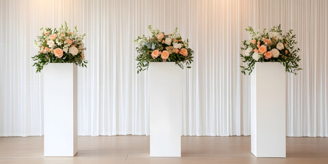 Three elegant floral arrangements on white pedestals against a flowing white backdrop. Perfect for weddings or events.