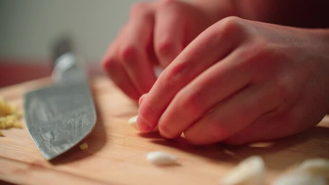 Peeling cloves of garlic by hand