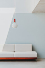 Modern minimalist living room with white sofa and pendant light in bright setting