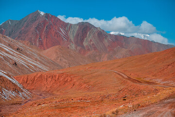 A mountain range with a road running through it