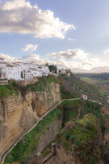 Obraz premium idyllic scenery of the city of ronda, malaga on the cliff with a blue cloudy sky