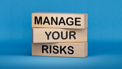 Manage your Risks symbol. Concept words Manage your Risks on wooden blocks. Business and Manage...