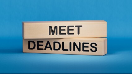 Meet Deadlines symbol. Concept word Meet Deadlines on wooden blocks.Business and Meet Deadlines...