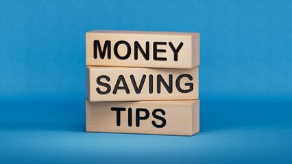 Money saving tips symbol. Concept words Money saving tips on wooden blocks.Business and Money saving tips concept. Copy space.3D rendering on blue background.