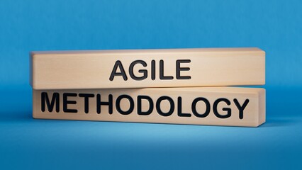 wooden cubes and a wooden block with the text agile methodology. Wooden cube blocks. Copy space.3D rendering on blue background.