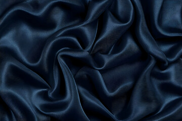 Obraz premium Dark Blue Satin Fabric Drapes Elegantly with Soft Folds and a Luxurious Texture