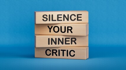 Silence your inner critic symbol. Wooden blocks with words Silence your inner critic.Business and Silence your inner critic concept.3D rendering on blue background.