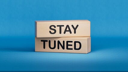 Stay Tuned symbol. Wooden blocks with words Stay Tuned Business and Stay Tuned concept. Wooden cube blocks. Copy space.3D rendering on blue background.
