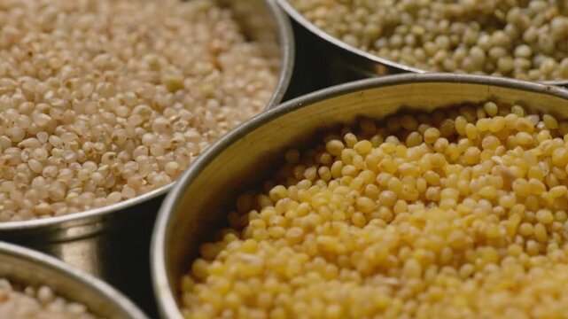 all types of healthy millet grains stored in the steel bowls, close up, parallax shot, 4k