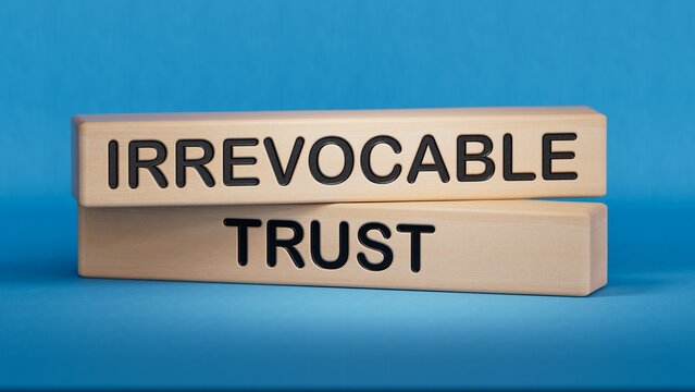 Text IRREVOCABLE TRUST writing in Wooden blocks. Business concept. Wooden cube blocks. Copy space.3D rendering on blue background.