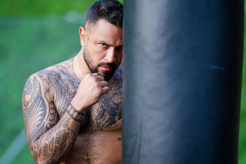Portrait of sexy boxer. Man boxer face close up. Fists fight. Mans fight, punches. Kicks up. In the outdoor boxing arena. Man ready for boxings challenge. Man fight. Boxings fight. Boxing sport.