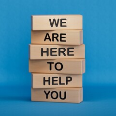 We are here to help you symbol. Concept words we are here to help you on wooden blocks.Business and...
