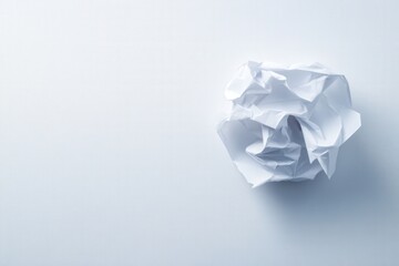 crumpled piece of white paper on a white background