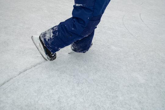 Snow-Covered Ice Skates on a Frozen Rink