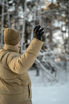 Man playing with snow in a winter forest near Oslo