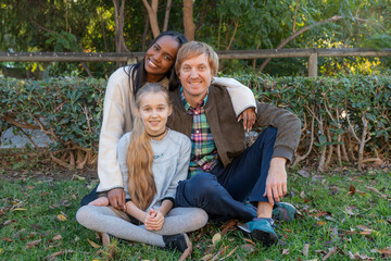 Happy multiethnic family hugging and smiling