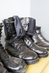 Dusty leather combat shoes with laces on shelf