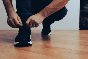 Running shoes man tying shoe laces. Athlete preparing work out