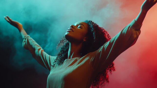Young woman letting go of problems , and feeling free with arms in the air. Praise and worship concept.