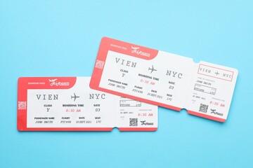 Travel agency. Flight tickets on light blue background, top view