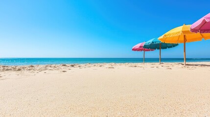 Colorful beach umbrellas on sunny sandy beach. Vacation travel background