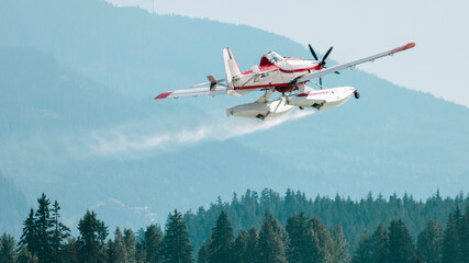 Aerial firefighting plane skims a lake to collect water