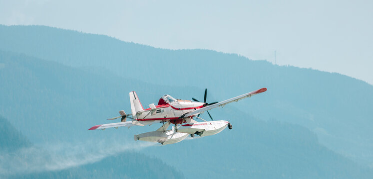 Water plane takes off from a lake, ready to fight nearby flames