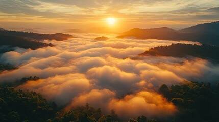 A breathtaking sunrise over misty mountains, casting warm light on the clouds below.