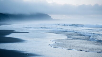 Fototapeta premium Misty Morning Beach with Rolling Waves and Foamy Shoreline