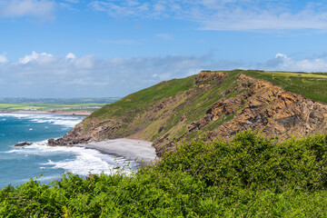The cliffs and beach in Millook Haven, Cornwall, England, UK