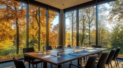 Conference room set up for sessions, large windows offering a serene view of autumn trees, creating a peaceful and inspiring atmosphere
