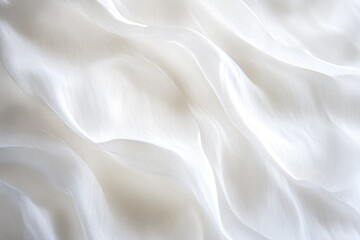 A close-up shot of white fabric with intricate details