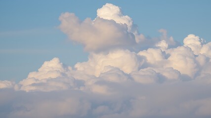 A breathtaking panoramic view of fluffy cumulus clouds against a clear blue sky, showcasing nature's beauty and serene atmosphere.