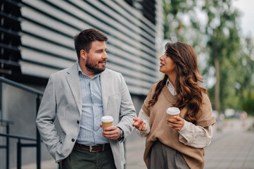 Business people having informal conversation walking outdoors