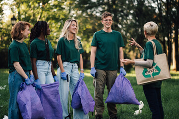 Group of volunteers collecting garbage in park