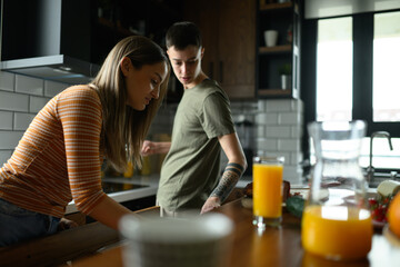 Lesbian couple in love preparing breakfast in modern kitchen