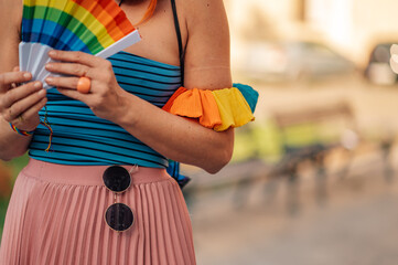 Woman holding rainbow fans celebrating lgbtq plus pride month