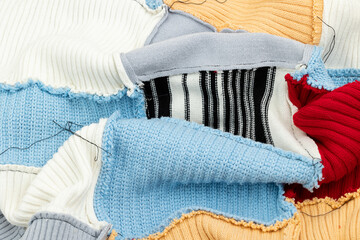 The reverse side of a knitted patchwork blanket