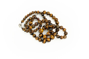 Tiger eye stone beads on a white background