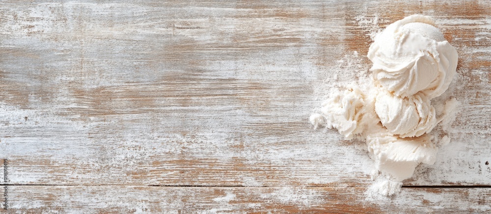 Poster texture of spilled white ice cream on rustic wooden table surface with ample copy space for text