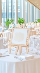 Blank canvas on an easel surrounded by tableware and wine glasses for a creative workshop event.