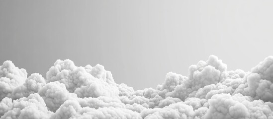 Fluffy white clouds in a monochrome sky with gradient background and ample copy space for text placement