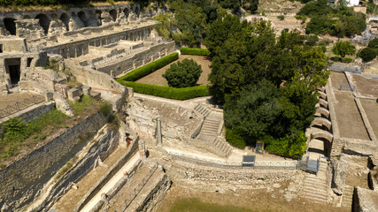 Fototapeta premium Aerial view of the Villa of the Ambulatio located in the archaeological park of Baia, a hamlet of Bacoli, near Naples, in Campania, Italy. It is a series of terraces leading to the sector of Mercury.
