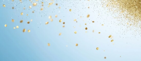 Gold glitter particles scattering on a blue background with copy space for text insertion