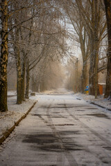 Beautiful snowy morning with a lot of snow, landscape in the town , sunrise landscape.Road in the city ,carage and streets.Sunny days and sunlights through the trees . Landscape and christmas mood