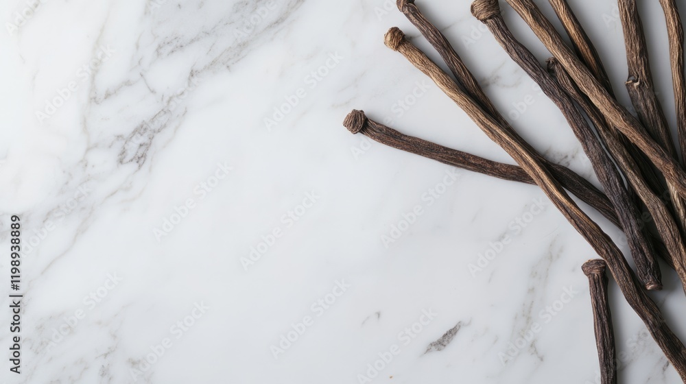 Poster dried vanilla pods arranged on a marble surface with copy space for text or design elements