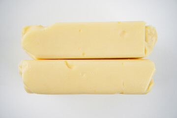 Top view of cheddar cheese blocks stack isolated on white background